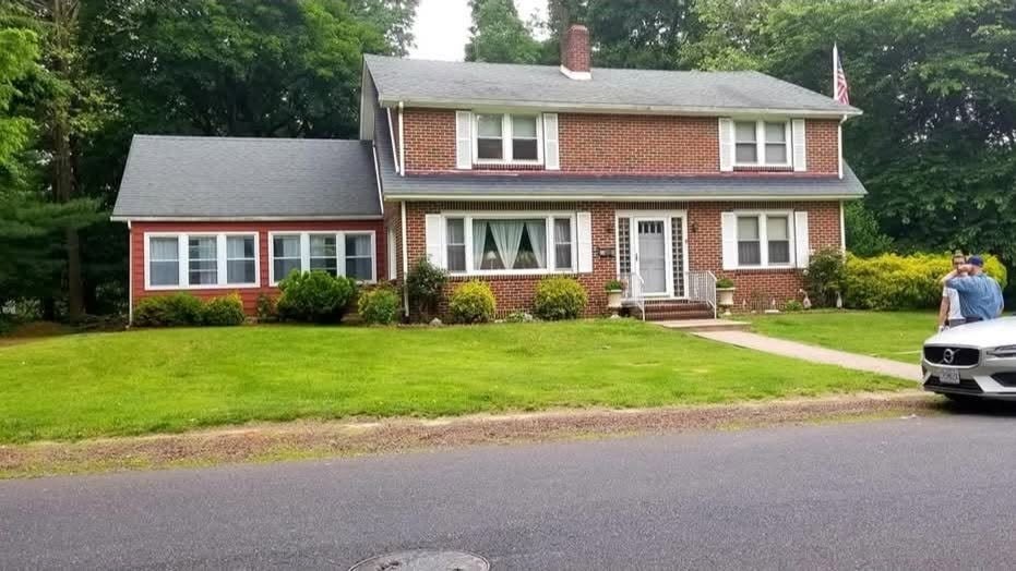 Before — colonial brick house without pool